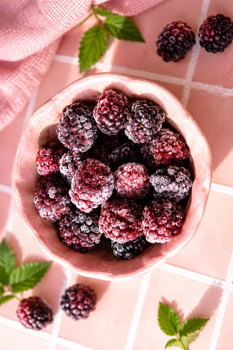 A bowl of frozen blackberries.