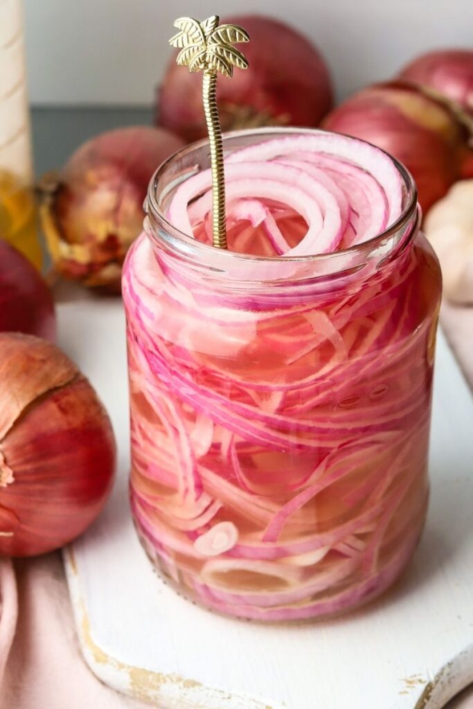 An open jar of spicy pickled onions