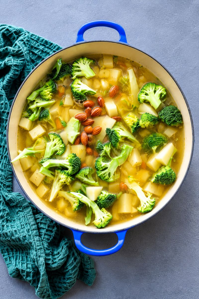 Broccoli, potatoes and almonds simmering in vegetable stock