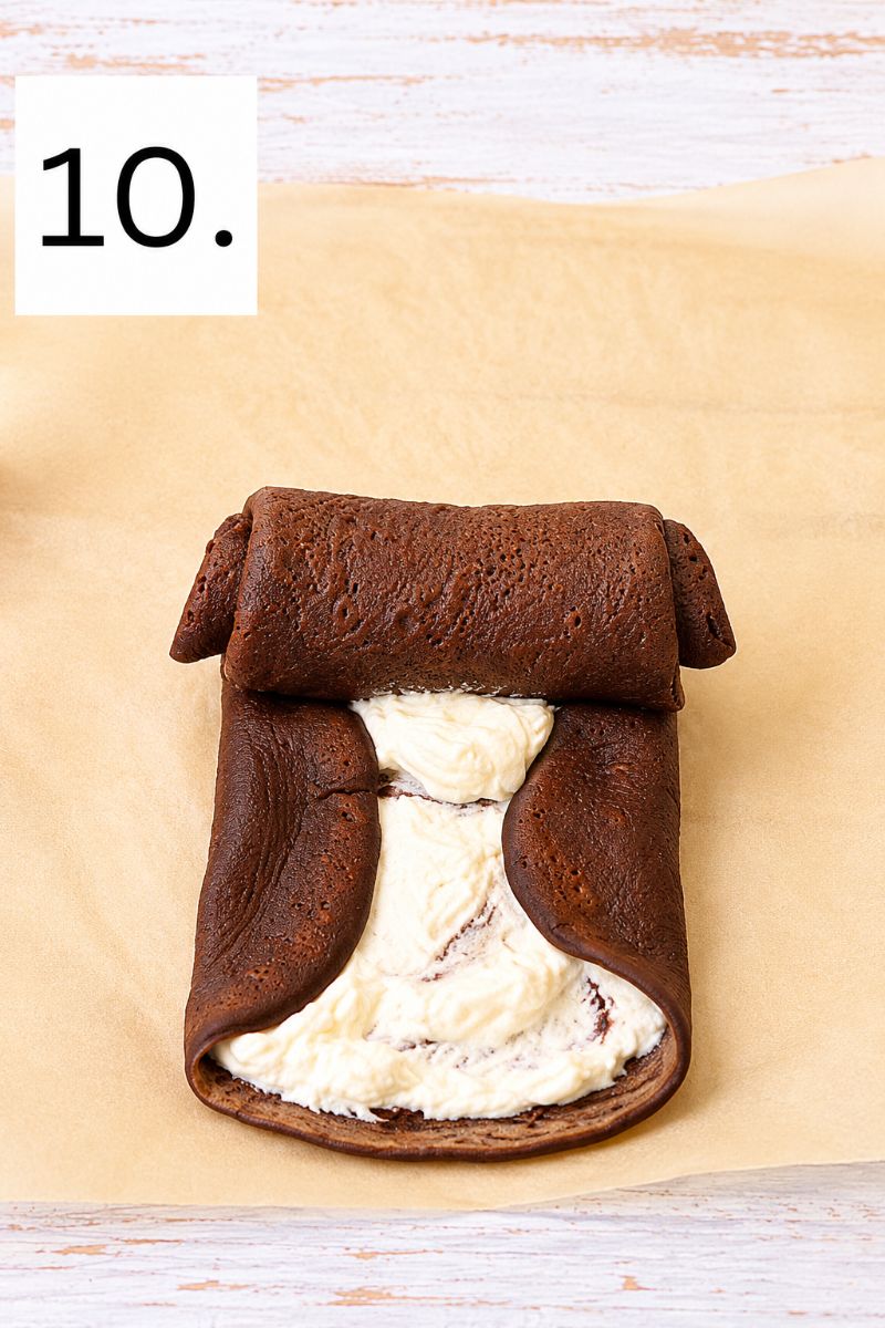 Chocolate crepes folded inward around a creamy whipped cream and Nutella filling.