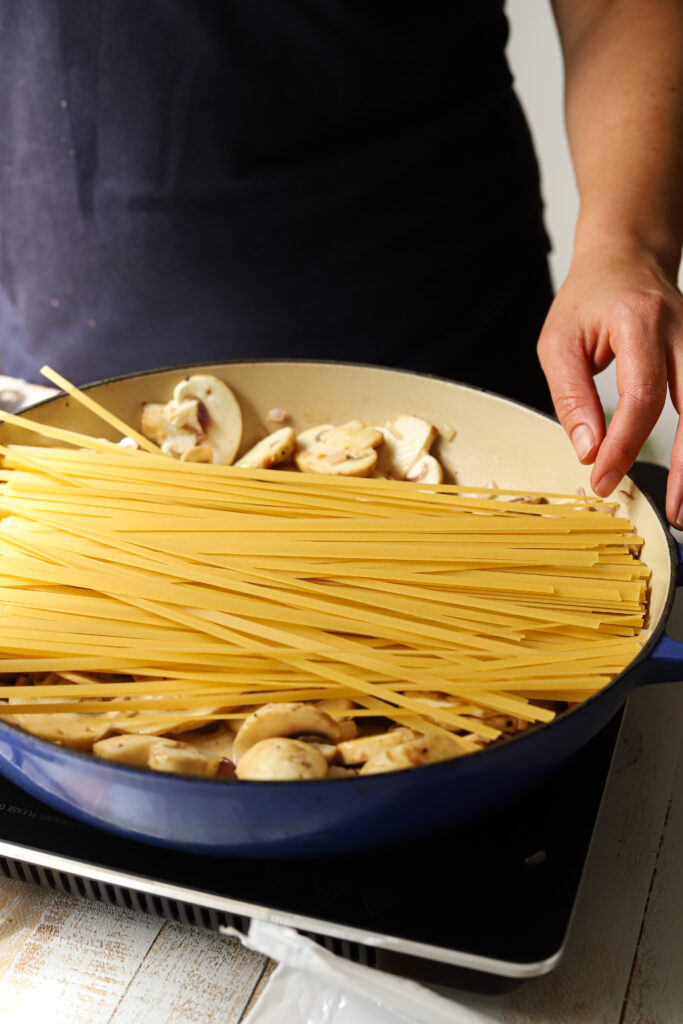 Add the pasta to the mushrooms.