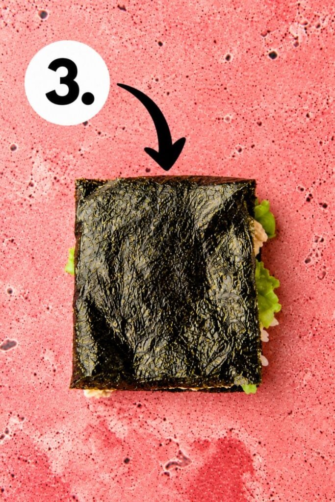 Final fold: Folding the remaining nori seaweed over the fillings to complete the homemade sushi wrap.