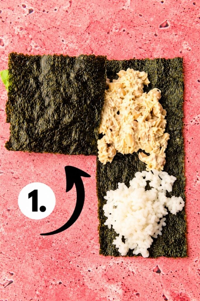 First fold: Folding one corner of a nori seaweed sheet over the chickpea filling to make a sushi wrap.