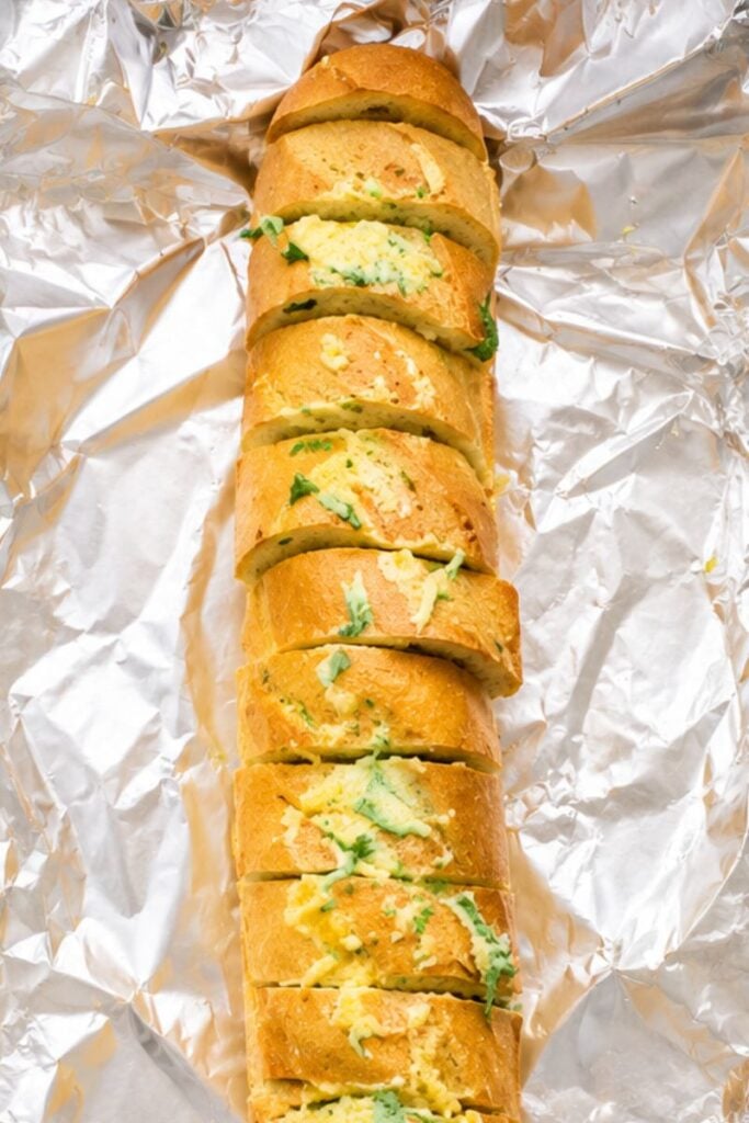 Garlic and parsley butter spread between the slices of a French baguette