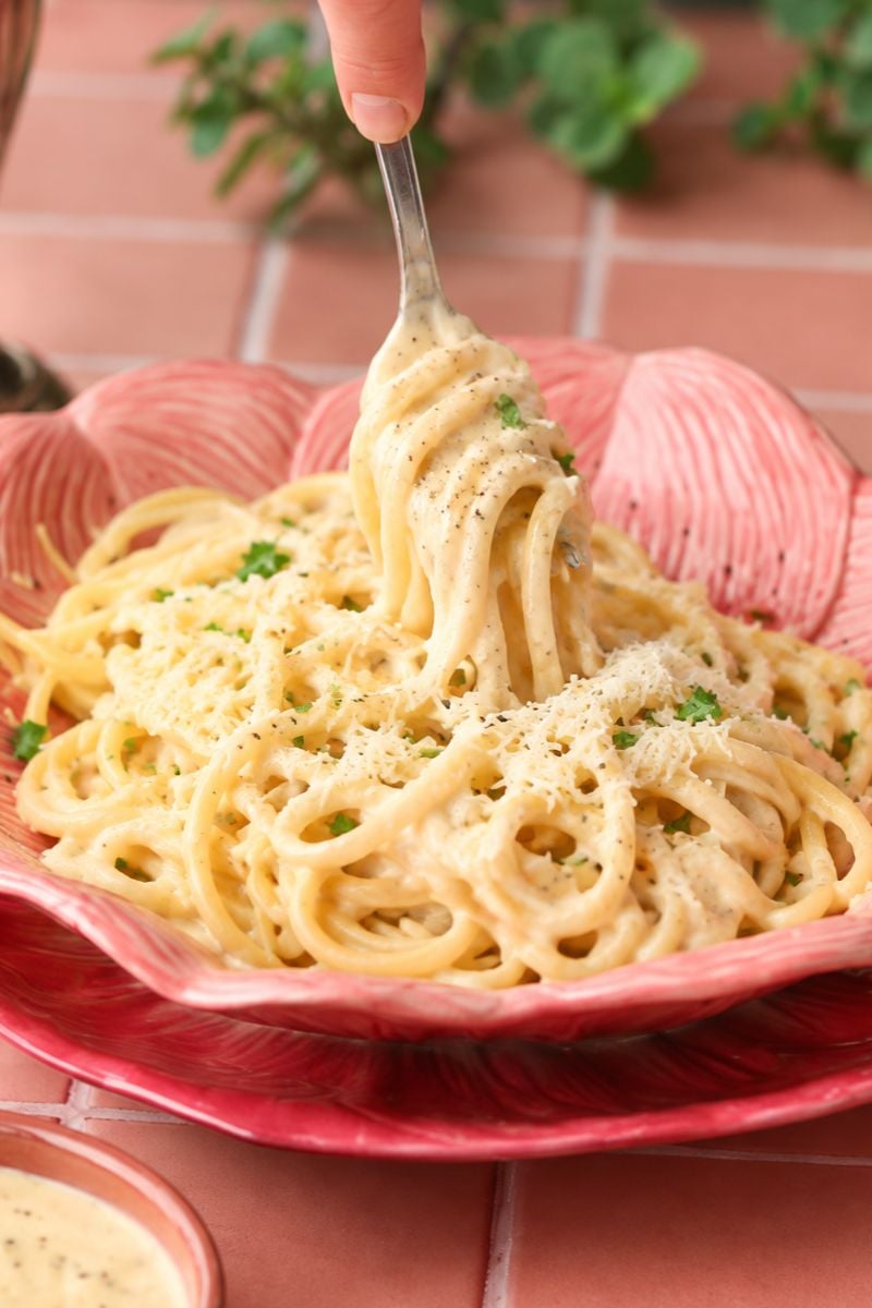 Creamy garlic parmesan pasta being twirled with a fork.