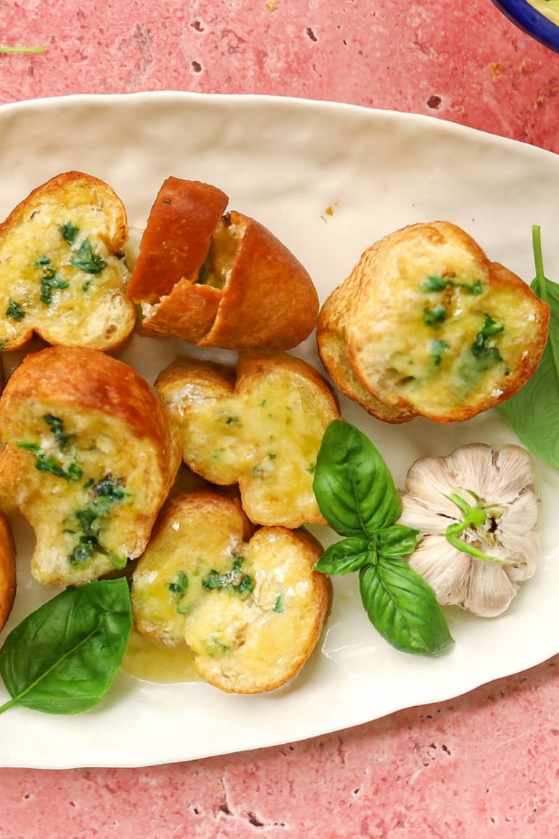 Garlic bread and melted cheese on a platter. 