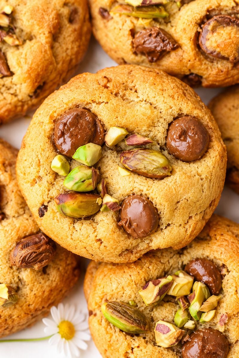 Close-up of golden pistachio chocolate chip cookies with crunchy pistachios and chocolate chips.