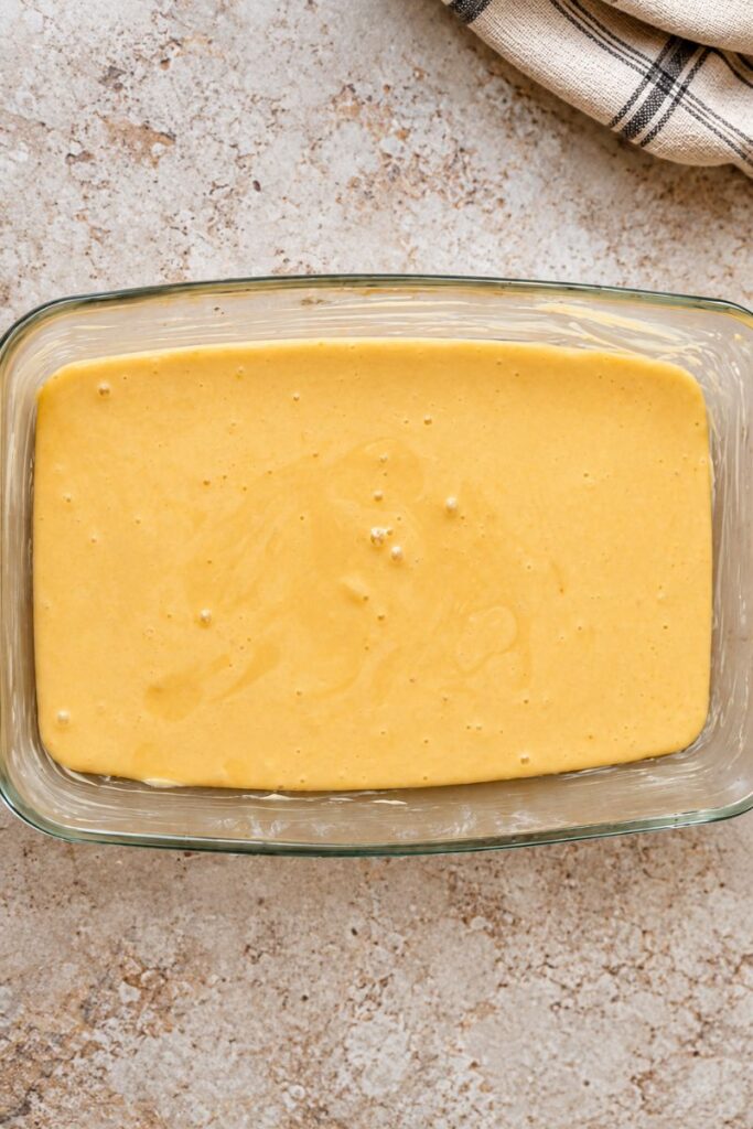 Malva pudding batter in the baking dish. 
