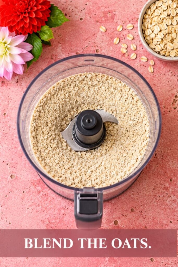 Rolled oats in a blender ready to be blended into oat flour.