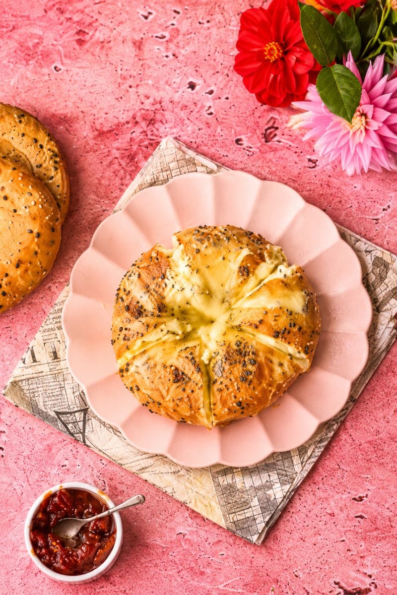 Cream cheese stuffed bagel cut into sections, showing the soft, creamy cheese filling inside.