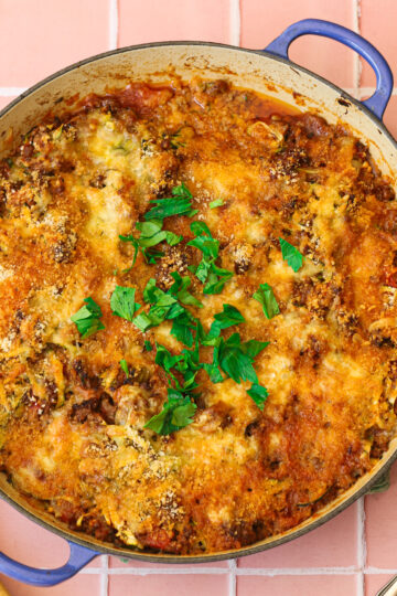 Ground beef and zucchini casserole baked in a dutch oven.