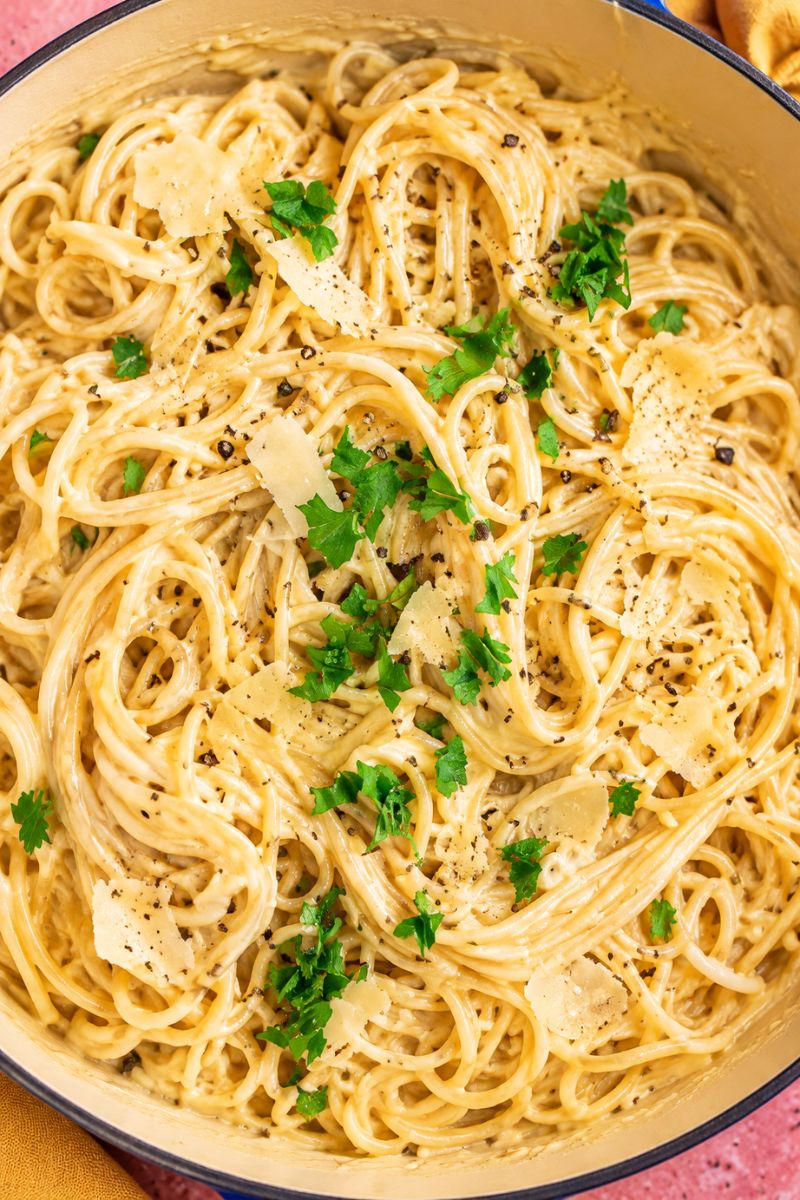 Creamy spaghetti Alfredo with Parmesan cheese, fresh parsley and black pepper.