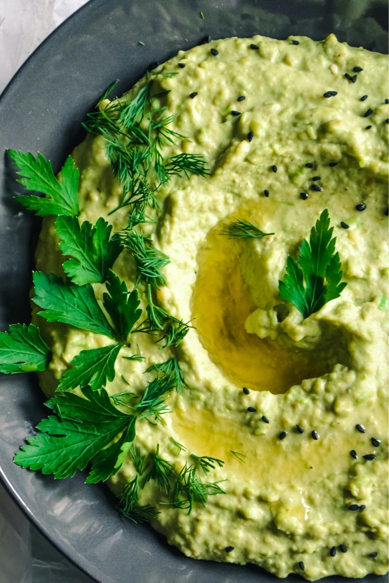 7 substitutes for dill. A bowl of creamy, dip with dill and parsley sprinkled on the top