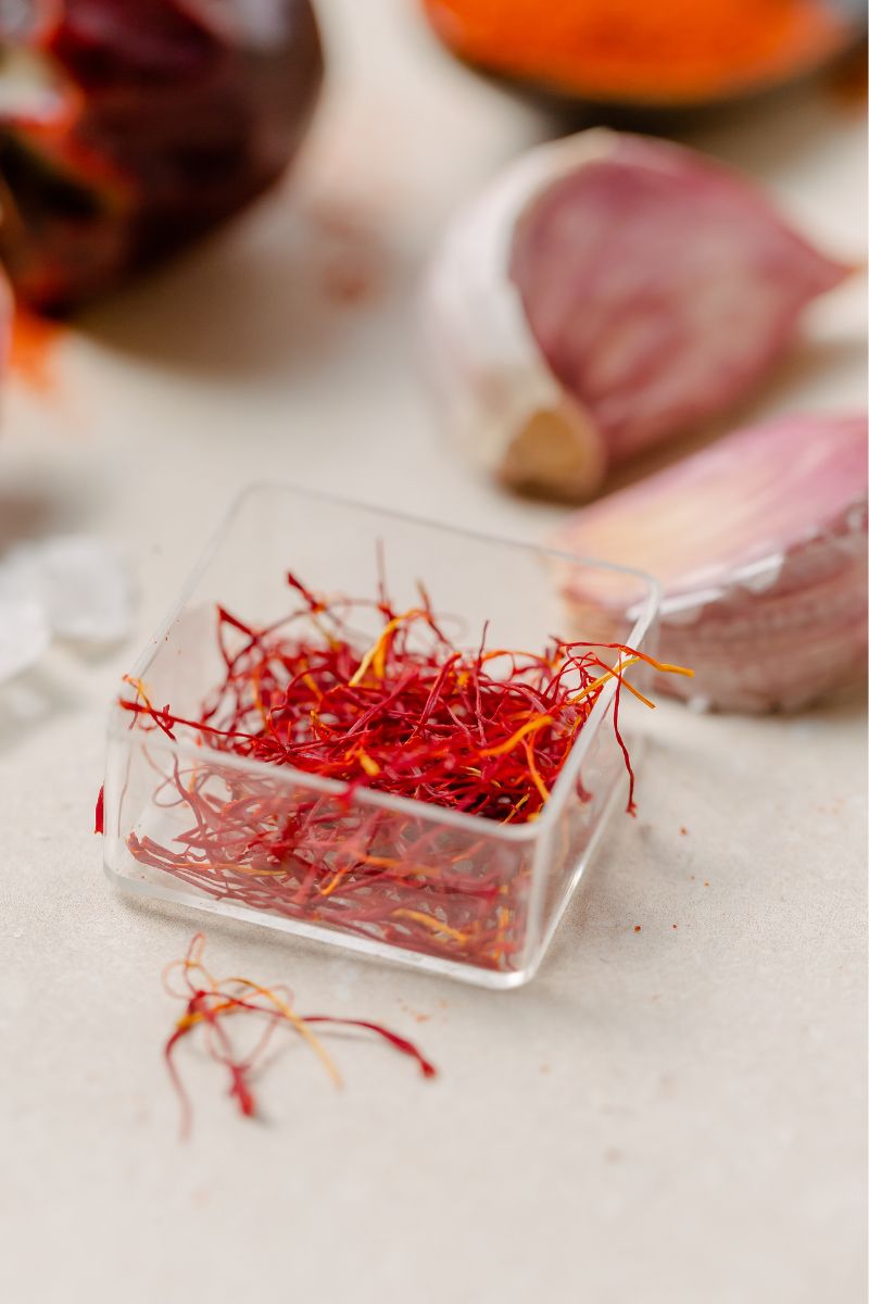Saffron threads in a small glass container.
