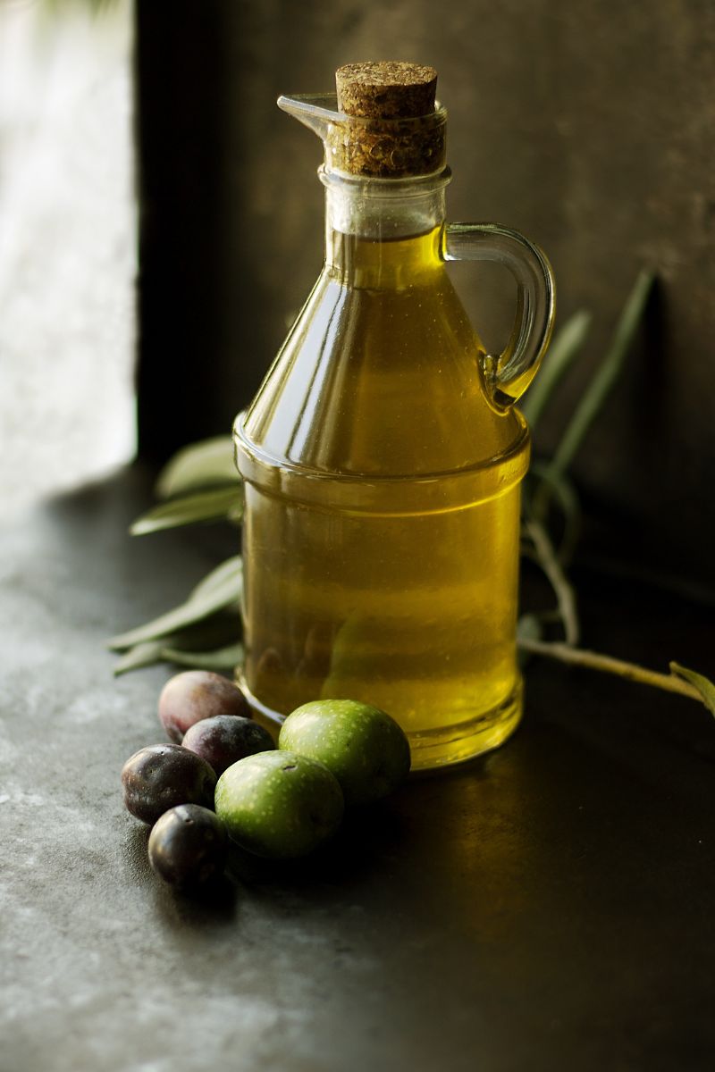 Olive oil with a few olives on the side.