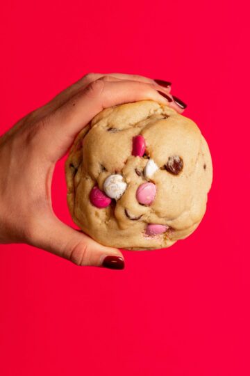 Holdling a cookie. How many pounds are in a gram? This will help you when you make your next recipe.