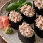 Gunkan sushi with creamy tuna filling wrapped in nori.