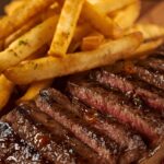 Cooked minute steak and fries.