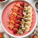 Strawberry smoothie bowl with toppings.