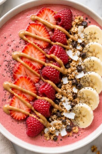 Strawberry smoothie bowl with toppings.