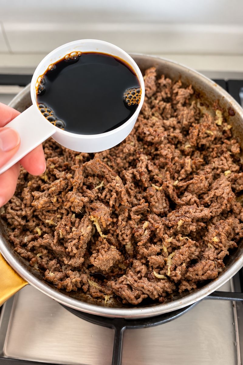 Adding the soy sauce. 
