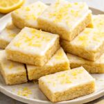 Lemon cookie bars on a plate.