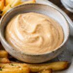A bowl of miso mayo with French fries.
