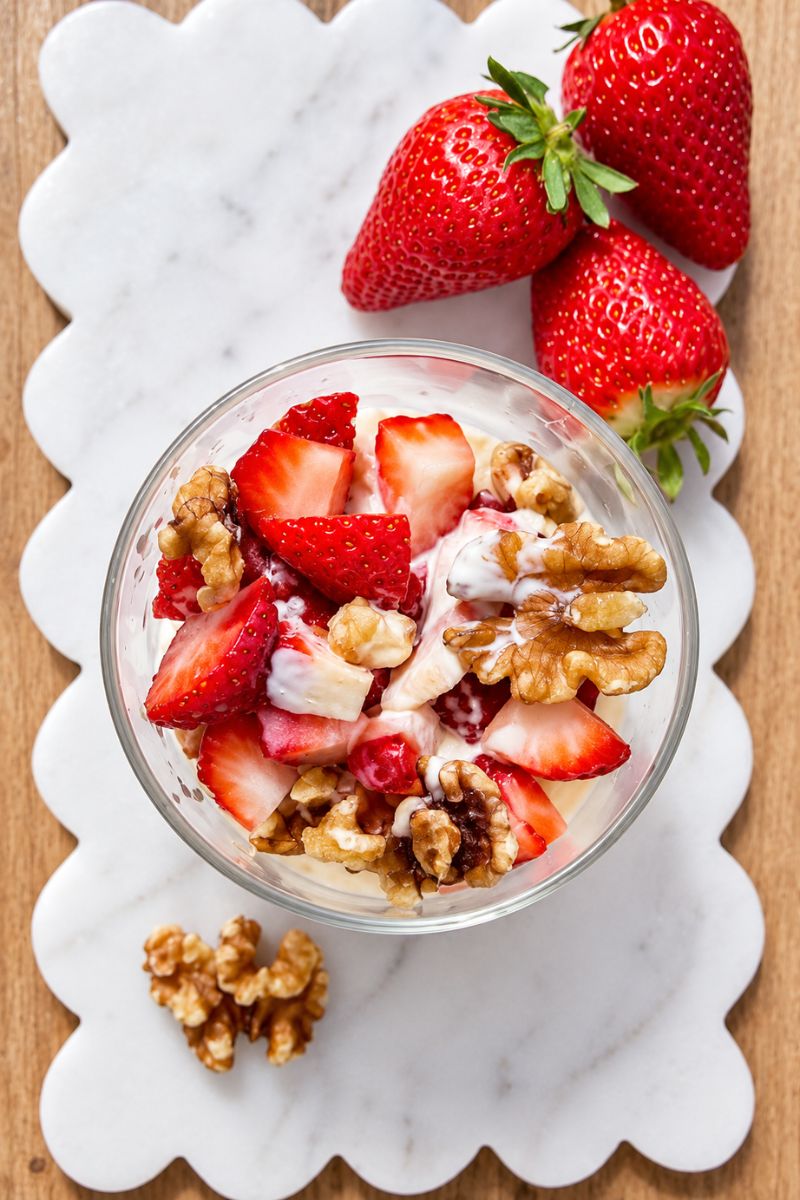 Semolina dessert with honey, cream, berries and nuts.