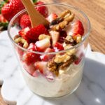 Semolina dessert with honey, cream, berries and nuts.
