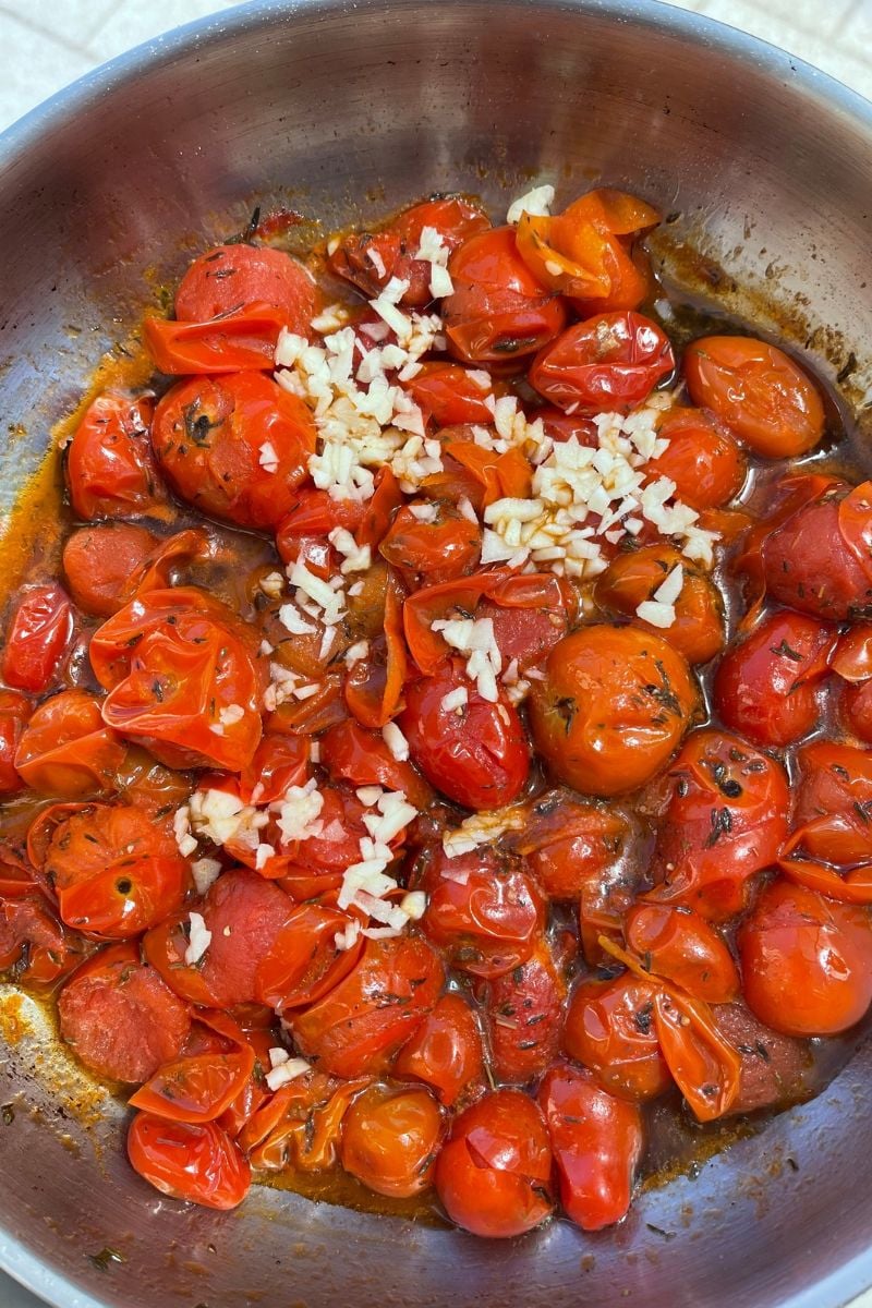 Cooked cherry tomatoes with added garlic.