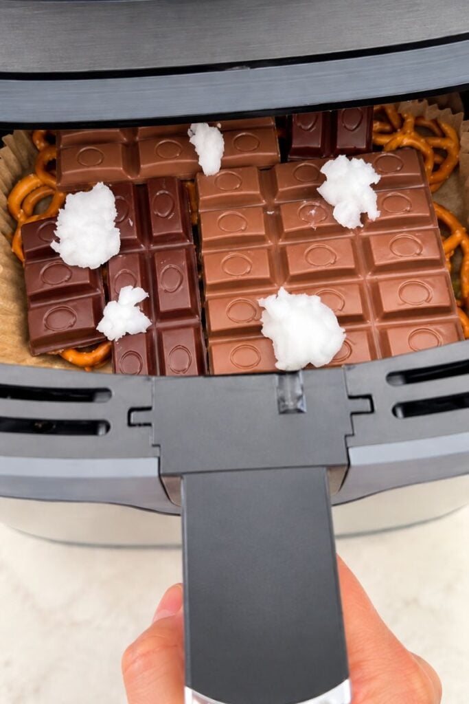 Coconut oil added to chocolate and pretzels before air frying.