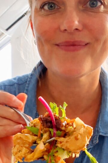 Holding a fork with crispy rice salad and chicken (high protien)