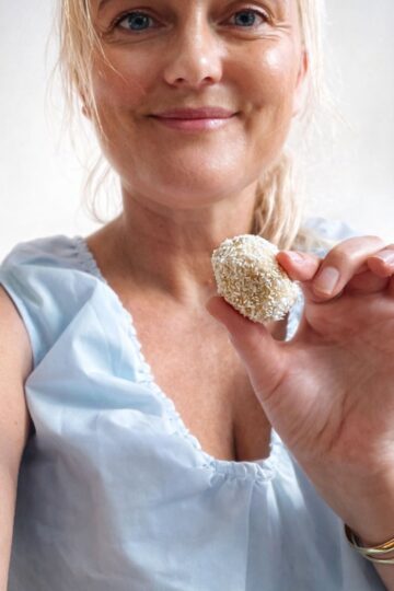 Holding a lemon energy ball.
