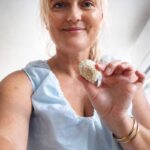 Holding a lemon energy ball.