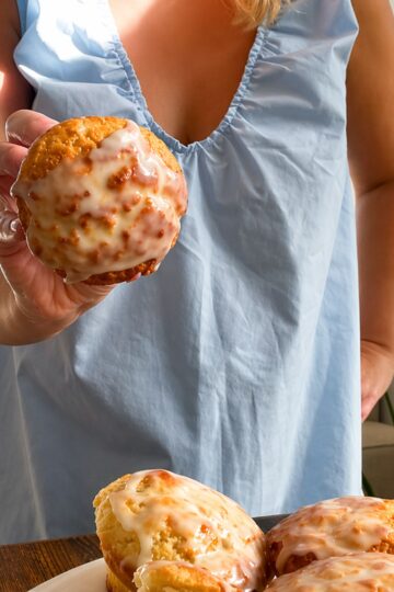Holding a moist lemon muffin with a lemon sugar drizzle.