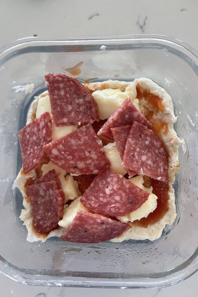 Pizza dough with toppings. 