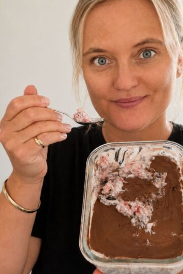 Eating a bowl of strawberry chia pudding.