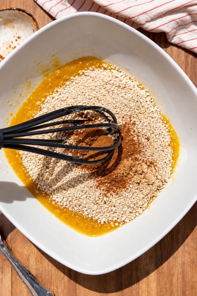 Blended oats and pumpkin pie spice added to muffin batter.
