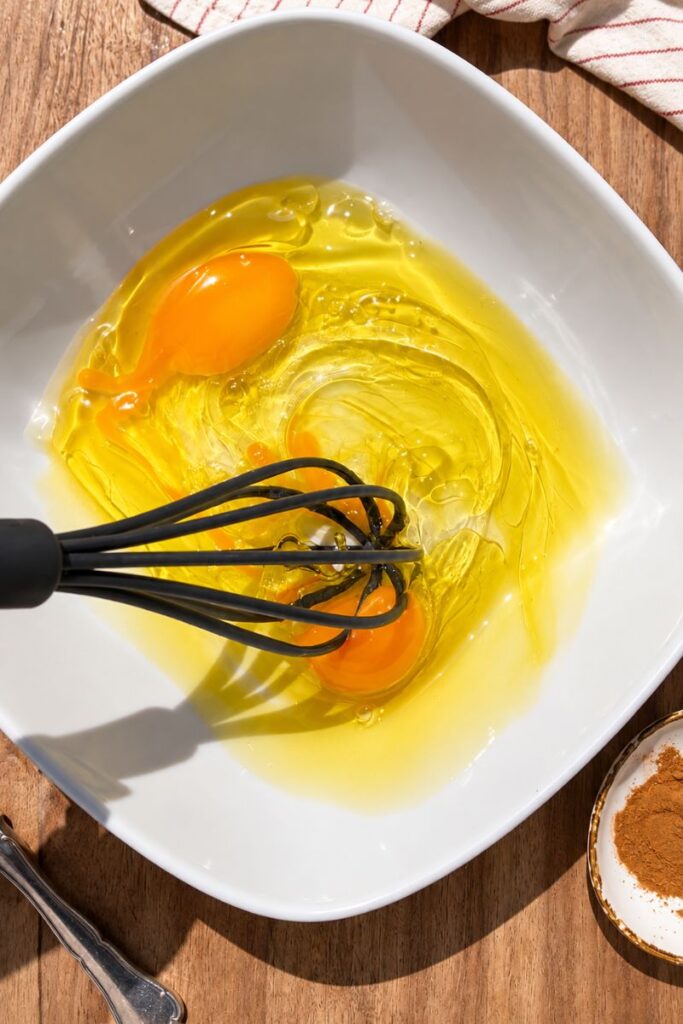Eggs being whisked for healthy pumpkin muffins.