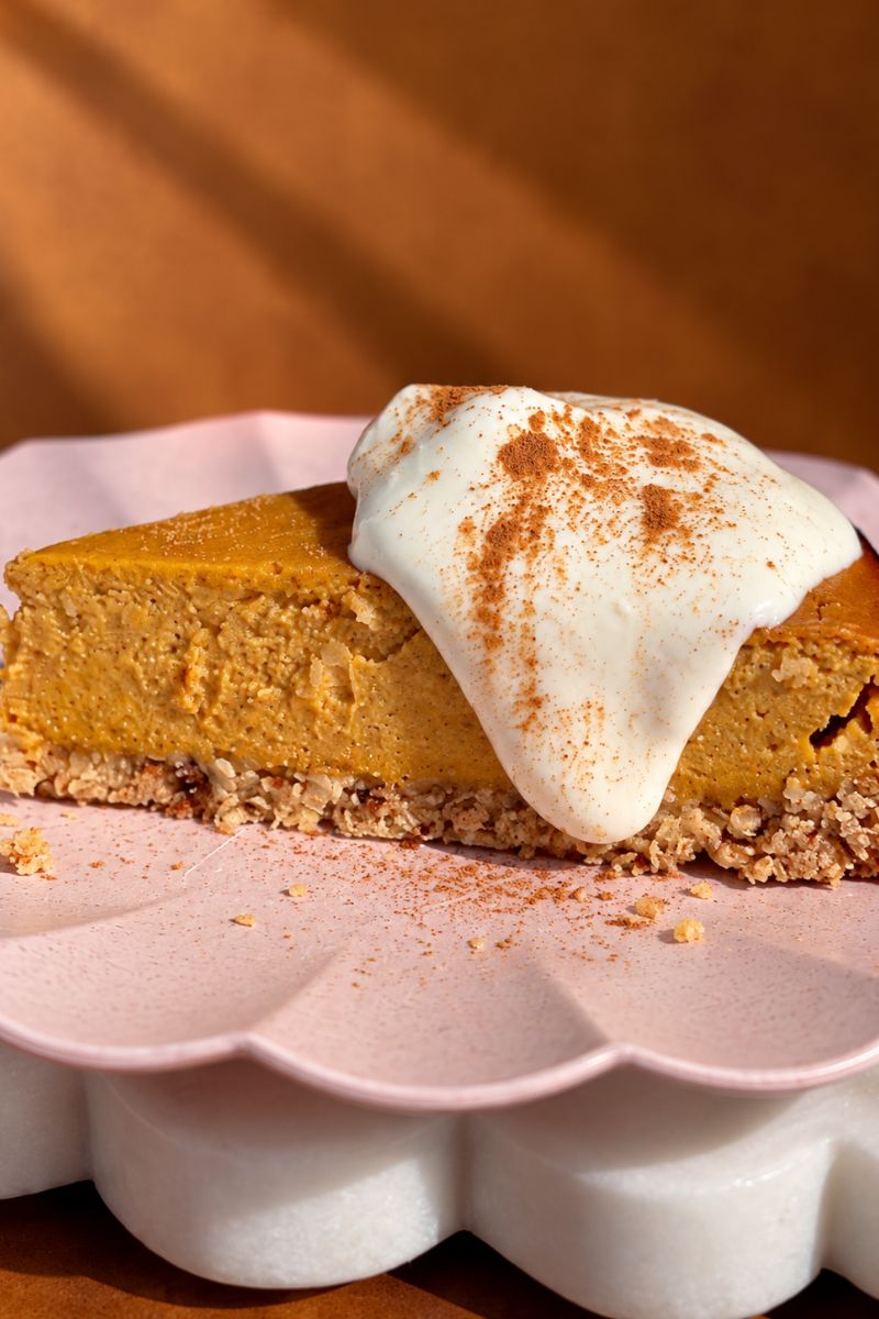 Slice of pumpkin cottage cheese cheesecake showing the creamy pumpkin filling