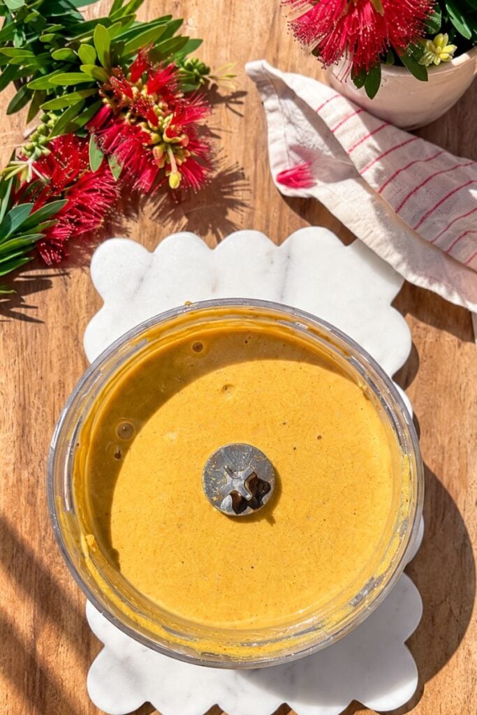 Blended pumpkin cottage cheese cheesecake filling ready to pour into the crust
