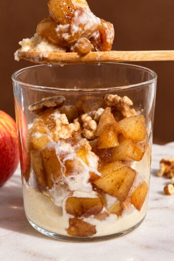 Spoonful of creamy semolina pudding with warm cinnamon spiced apples.