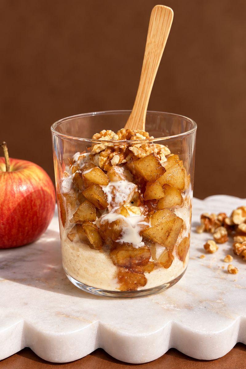 Creamy semolina pudding topped with cinnamon spiced apples, cream and walnuts