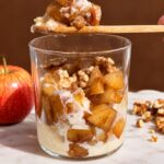 Spoonful of creamy semolina pudding with warm cinnamon spiced apples.