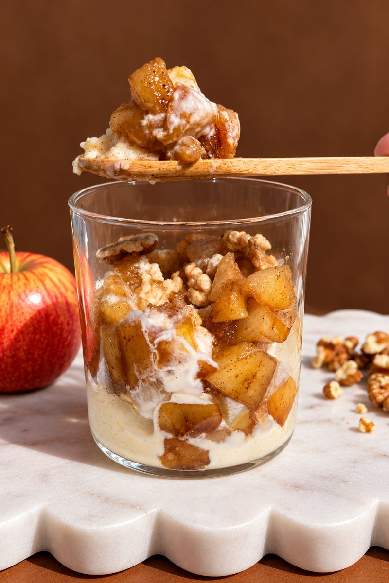 Spoonful of creamy semolina pudding with warm cinnamon spiced apples.